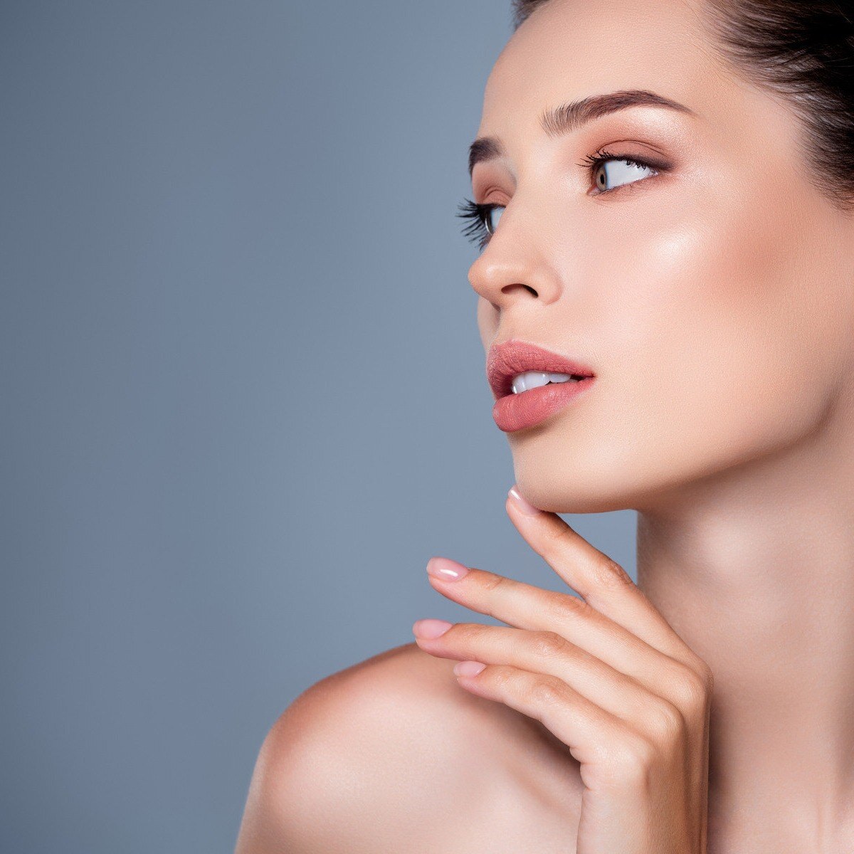 Young woman looking to the left, with clear, tight skin